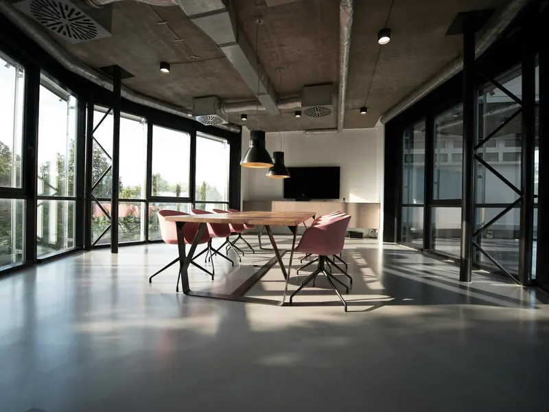 Bright boardroom with a long table and large windows