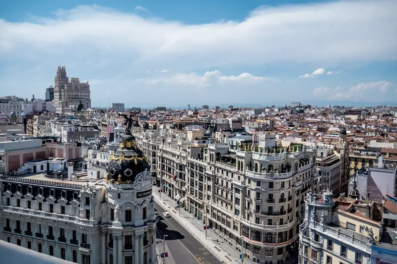 Madrid rooftops and Gran Vía under a blue sky