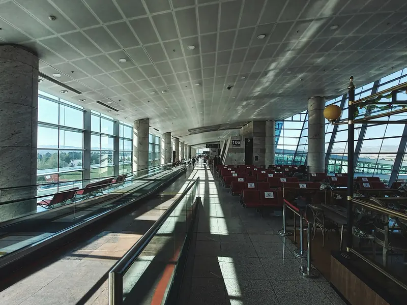 Quiet airport departure hall with floor-to-ceiling windows