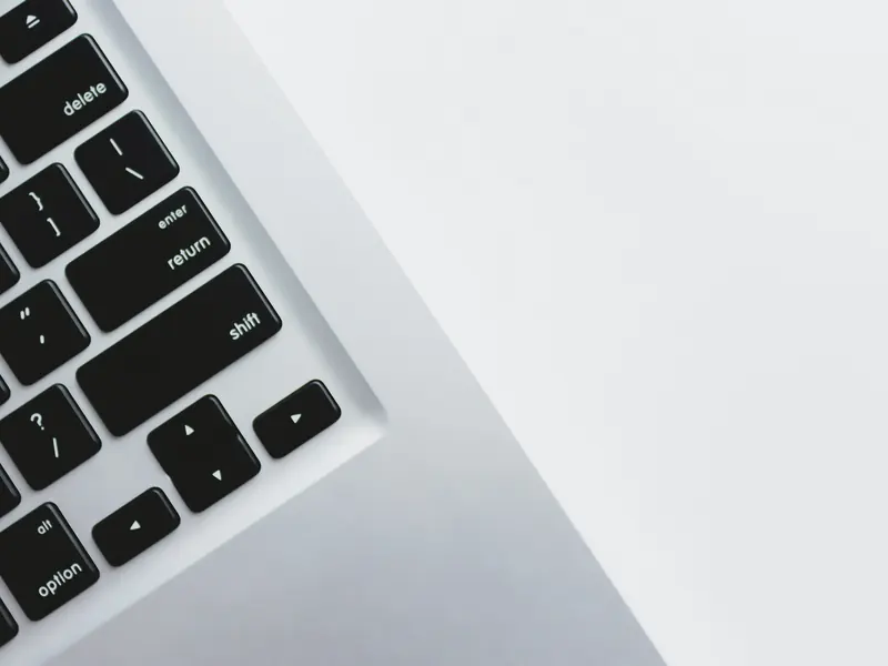 Close-up of a laptop keyboard on a white desk